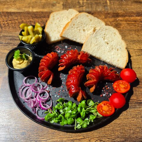 Grilled Hungarian Debreceni sausage with bread mustard and pickles