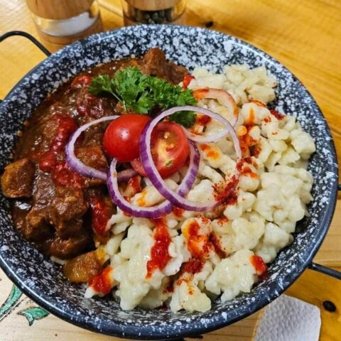 Hungarian beef stew with red wine sauce and homemade dumplings