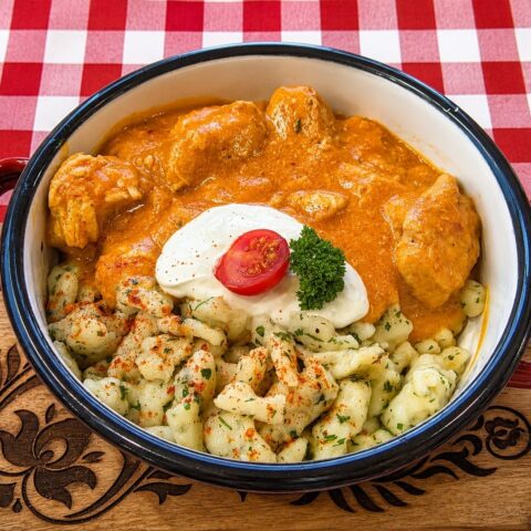 Hungarian chicken paprikash with creamy paprika sauce and homemade dumplings